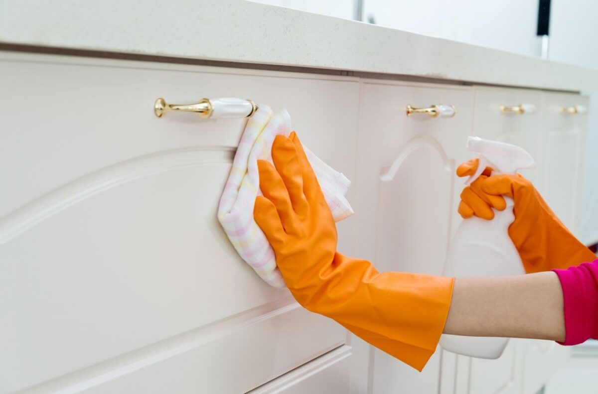 Maid in T.O team completing cabinet cleaning in Richmond Hill home with careful kitchen surface and cabinet detailing.