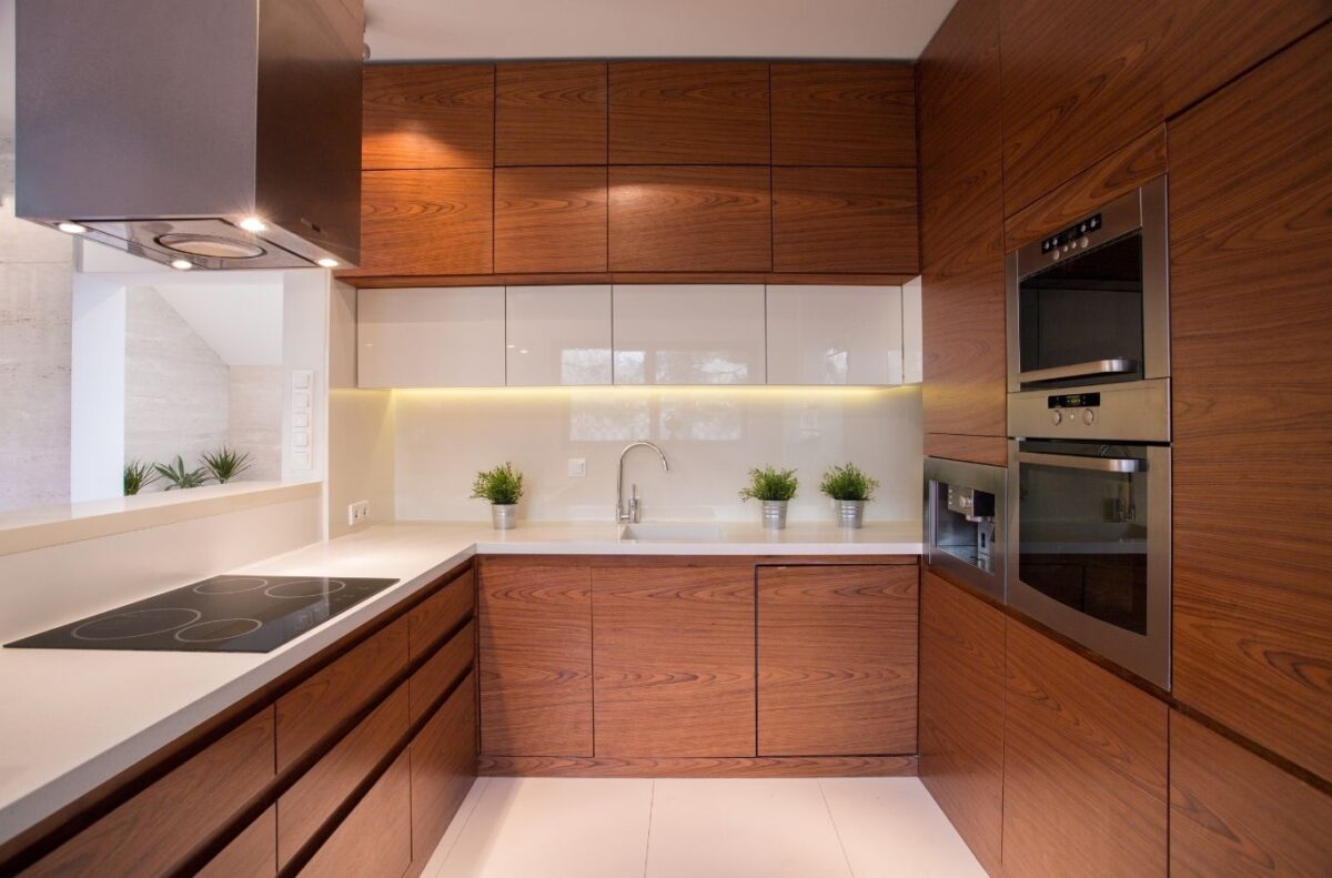 Maid in T.O team completing cabinet cleaning in Etobicoke condo with careful kitchen surface and cabinet detailing.